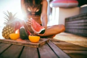 lady outside eating fresh fruit platter healthy snacks