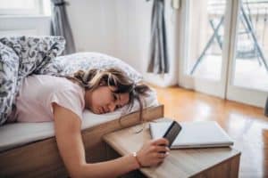 woman in bed unable to sleep due to smartphone 1